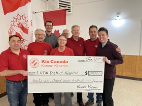 Holding the check are the Executive Director of the Lake of the Woods District Hospital Foundation, Myra Trebilcock (right) and President of the Kenora Kinsmen, Travis Sokolyk, along with more local Kinsmen in the back.