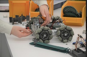A student in the Lasalle Secondary School Robotics Club fine tunes the wheels of a robot set to be used at the Skills Ontario Competition in Toronto this spring.