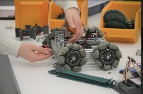 A student at the Lasalle Secondary School Robotics Club adjusts the wheels of a robotic set that is scheduled to compete in Toronto's Skills Ontario Competition this spring.