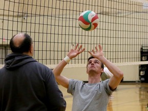 Cambrian Golden Shield men's volleyball player Jack Daley, right, takes part in a setting drill with head coach Dale Beausoleil at Cambrian College in Sudbury, Ontario on Wednesday, February 15, 2022.