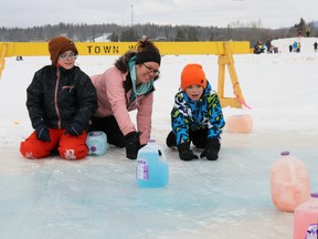 Chelsye Green and kids Nathan, 12, and Carsin, nine, competed in crokicurl at Rotary Park Saturday, during the Family Day Winter Carnival. Crokicurl, a cross between curling and the crokinole board game, was a new feature at the annual carnival.