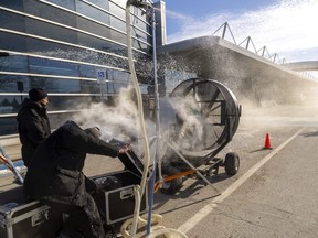 A TV crew shoots a scene for an upcoming TV series at London International Airport on Tuesday, Jan. 31, 2023. Jaizen Torres, left, runs a smoke generator and Jacob Solomon, right, runs a snow maker, while Allessandro Beninati, wreathed in smoke, operates a fan and Matthew Tulk, the key special effects guy for the TV show The Pradeeps of Pittsburgh, checks to see whether the results of their labours look good. (Mike Hensen/The London Free Press)