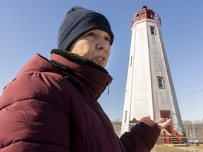 Tracy Farmer, who lives near the 183-year-old lighthouse in Port Burwell, says the building needs extensive repairs but should be kept as a tourist attraction.  The municipality of Bayham closed a section of road near the lighthouse this week because of the possibility it could be blown over by strong winds.  (Mike Hensen/The London Free Press)
