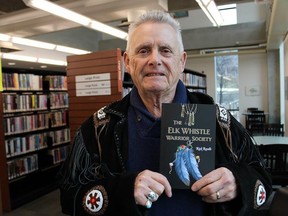 Napanee author Rick Revelle holds a copy of his fifth and latest novel called The Elk Whistle Warrior Society. He noted that the blue colour of the feathers in the group's motto stands for "passion." He will be at the Quinte Mall Chapters on Saturday, Feb. 18 from noon to 3 p.m. to sign copies. JACK EVANS PHOTO