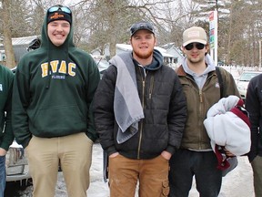 Matthew Beal of Belleville, (second from left) a first time ice
diver, admitted he was nervous but got moral support from some of his fellow Belleville and Tweed buddies as they splashed in for the Cancer Society. JACK EVANS PHOTO