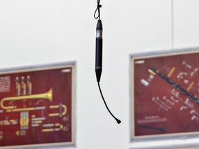 One of six new microphones hangs from the ceiling above the concert band area in the music classroom at Assumption College School.