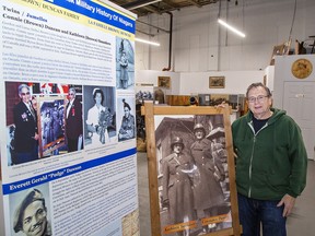 Bob Ion, chair of the Canadian Military Heritage Museum in Brantford shows one of the information banners on loan from the Niagara Military Museum that chronicles the black community's involvement in wars ranging from the Loyalist era to Afghanistan.