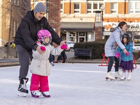 Mike Huynh of Brantford helps his daughter Vanessa, age 4 learn to skate on the outdoor rink at Harmony Square.