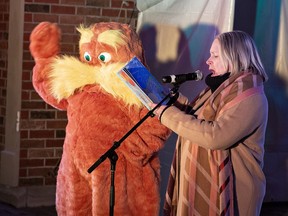 Heather Wilson, chair of the Brant Community Healthcare System Foundation reads The Lorax by Dr. Seuss to the crowd gathered for Family Day activities at Harmony Square.