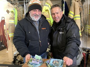 A quickly organized fundraiser for restaurateur Scott Dammeier drew 400 to 500 people to the Paris Fire Station Saturday, Feb.  18 where companies donated swag to be handed out and the community donated funds, such as these collected by Tigercat volunteers Joe Azzopardi and Rob Pentesco.  SUSAN GAMBLE PHOTO