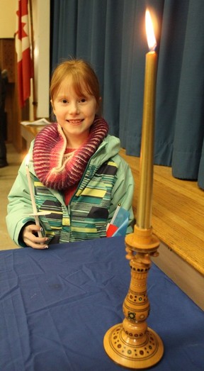 Eight-year-old Winifred Carriere was among the youngest participants on Friday, Feb.  24 at a candlelit vigil in solidarity with Ukraine held at St. John the Baptist Ukrainian Catholic Church.  This and other sombrer events were held across Canada to mark the first anniversary of the Ukraine war.  MICHAEL RUBY