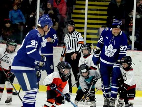 Toronto Maple Leafs alumni Steve Thomas, left, and Al Iafrate  lead the Tim Hortons Timbits during Sunday's alumni game at the Brockville Memorial Centre. (RONALD ZAJAC/The Recorder and Times)