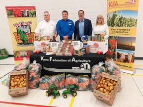 The Kent Federation Agriculture celebrated Canada's Ag Day on Feb. 15 with donations to the Salvation Army and Outreach for Hunger food banks. Seen here with a representation of the local produce and other food items regularly donated to local food banks is, from left, Salvation Army of Chatham-Kent Major Stephen Holland, KFA president Brad Snobelen, Chatham-Kent Mayor Darrin Canniff and Outreach for Hunger executive director Brenda LeClair. Ellwood Shreve/Postmedia