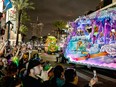 Revellers catch beads from a float in the 2023 Krewe of Proteus parade during Mardi Gras in New Orleans, Louisiana, on February 20, 2023. (Photo by CHANDAN KHANNA / AFP)