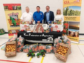 The Kent Federation Agriculture celebrated Canada's Ag Day on Wednesday with donations to the Salvation Army and Outreach for Hunger food banks. Seen here with a representation of the local produce and other food items regularly donated to local food banks is, from left, Salvation Army of Chatham-Kent Major Stephen Holland, KFA president Brad Snobelen, Chatham-Kent Mayor Darrin Canniff and Outreach for Hunger executive director Brenda LeClair. (Ellwood Shreve/Chatham Daily News)