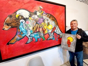 Aamjiwnaang First Nation artist John Williams is seen here in front of his art work 'Makwa Endaad – Bears Lodge' that he was commissioned to do by Rondeau Provincial Park for its visitor centre.  He is holding a winter-bird themed painting that was the focus of an art workshop he led at the visitor center Saturday during the Rondeau - Family Day Weekend - Cultural Celebration.  PHOTO Ellwood Shreve/Chatham Daily News