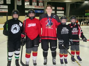 Recent gold medalist Jocelyn Amos, centre, attends professional ice skating coach Kathy McLlwain's morning session at the South Huron Rec Center in Exeter January 31.  Pictured with Amos (from left) are some of McLlwain's students: Ellie Heessels, Lyla Moore, Halle Grant and Jordan McCann.  Scott Nixons