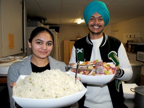 Community volunteers Jasmanpreet Kaur, left, and Akashdeep Singh, show some of the food served during the Unity in Community luncheon held at Know-St. Paul's United Church on Saturday February 4, 2023 in Cornwall, Ont. Greg Peerenboom/Special to the Cornwall Standard-Freeholder/Postmedia Network