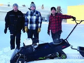 (L-R) Jeff Bakal, Trackinator creator Cam Bakal and John Maland teacher and ski-program leader Micheal Breker pose with the new ski track setter. (Supplied)
