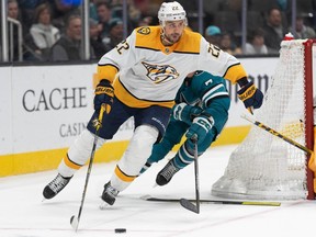 Nashville Predators right wing Nino Niederreiter (22) controls the puck during the second period against San Jose Sharks center Nico Sturm (7) at SAP Center at San Jose on Thursday, Feb. 23, 2023.