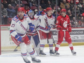 Soo Greyhounds forward Marco Mignosa hangs out in front of the Kitchener Rangers net with Matthew Andonovski (right) and Roman Schmidt (left) during first period OHL action on Friday night. The Hounds had a bad night, the Blueshirts roughing them up in a 10-2 win at the GFL Memorial Gardens.