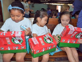 Children in Costa Rica check out their Canadian-packed Operation Christmas Child shoeboxes.