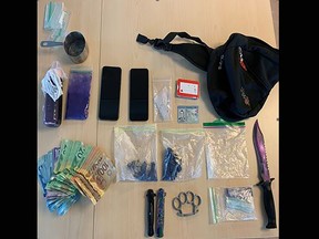 Fentanyl, carfentanil, crystal methamphetamine, cash and various weapons seized by Kingston Police on Feb. 16, 2023.