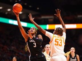 Kingston's Aaliyah Edwards of the UConn Huskies, wearing a mask to protect her broken nose, goes up for a layup against Jillian Hollingshead of the Tennessee Volunteers in an NCAA women's basketball game on Thursday, Jan. 26, 2023. The Huskies won, 84-67.