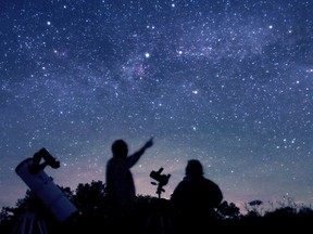 David Levy (pointing to the skies) visited the Dark Sky Viewing Area on Highway 41 north of Erinsville in June 2013 with Terence Dickinson, who died Wednesday, Feb. 1, 2023, at age 79.