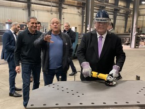 Ontario Premier Doug Ford practices his welding before announcing a $5.8 million investment to help junior mining companies explore for critical minerals.  ELAINE DELLA-MATTIA