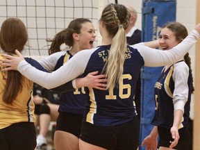 St. Mike's senior girls' volleyball team celebrates after sweeping SDSS to win the Huron-Perth championship.