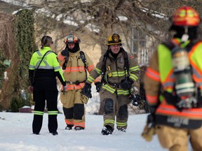 Petrolia and North Enniskillen and Plympton-Wyoming firefighters and Lambton paramedics work at an apartment building on Greenfield Street in Petrolia after a fire broke out there Sunday afternoon.  Terry Bridge/Sarnia Observer/Postmedia Network
