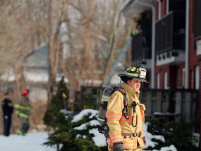 Petrolia and North Enniskillen and Plympton-Wyoming firefighters and Lambton provincial police and paramedics work at an apartment building on Greenfield Street in Petrolia after a fire broke out there Sunday afternoon.  Terry Bridge/Sarnia Observer/Postmedia Network