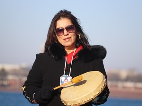 Marina Plain drums Tuesday during a flag raising at Sarnia's Waterfront as part of a No More Stolen Sisters march.