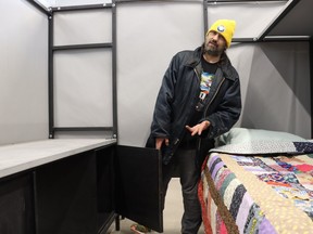 David Clarke shows a sleeping area in expanded space at the River City Vineyard shelter in Sarnia.
