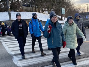 People participating in the Coldest Night of the Year fundraising walk in Simcoe cross the Queensway on Saturday afternoon. Walkers raised more than $50,000 for Youth Unlimited YFC Norfolk based in Simcoe. SIMCOE REFORMER