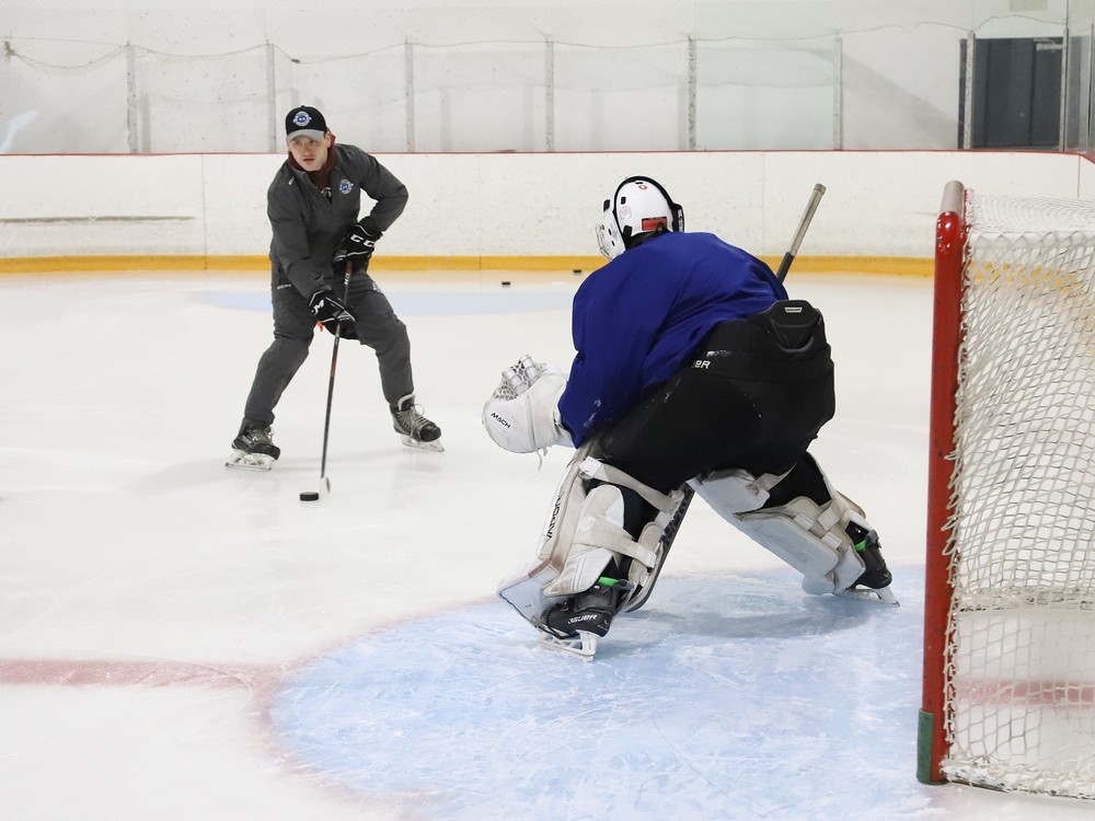 Mackenzie Savard, left, director of goaltender development at RHP Training Centre, puts Keiran Ouellette through a drill at the centre on Friday.