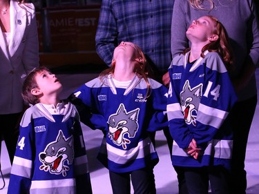Former Sudbury Wolves great Marc Staal, along with his family, including his kids, Jack, Emily and Anna, look up as their dadÕs number is raised to the rafters during a Wolves pre-game ceremony at the Sudbury Community Arena in Sudbury, Ont. on Friday February 3, 2023. John Lappa/Sudbury Star/Postmedia Network