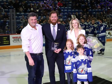 Sudbury Wolves owner Dario Zulich, left, presented a plaque to former Sudbury Wolves great Marc Staal as his family, including his wife, Lindsay, and their kids, Jack, Emily and Anna, look on at a Wolves pre-game ceremony at the Sudbury Community Arena in Sudbury, Ont. on Friday February 3, 2023. John Lappa/Sudbury Star/Postmedia Network