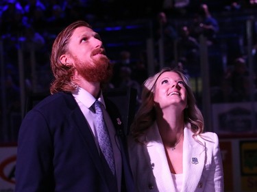 Former Sudbury Wolves great Marc Staal and his wife, Lindsay, look up as his number is raised to the rafters during a Wolves pre-game ceremony at the Sudbury Community Arena in Sudbury, Ont. on Friday February 3, 2023. John Lappa/Sudbury Star/Postmedia Network