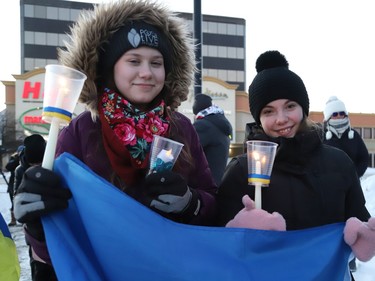Abigail Debruyn, left, and Sarah Wolski participated in a candlelight vigil to Stand with Ukraine, 365 Days of Resistance, in Sudbury, Ont. on Friday February 24, 2023.