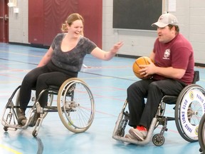 Katie Heap, left, on The Aquittables (Lefebvre & Lefebvre LLP) tries to steal the ball from Robert Mercer, Onondaga Volunteer Fire Department (Brant Station 6) during the 25th Wheelchair Basketball Tournament in Brantford Saturday.  CHRIS ABBOTT