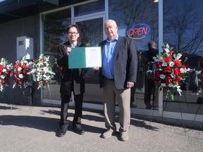 Doug Brunton, a Norfolk County Ward 5 Councilor, presents a certificate from the county to Jacky Yu, manager and co-owner of Hoy's Chinese Cuisine, recognizing the grand re-opening of Hoy's Chinese Cuisine in Simcoe on Feb.  14. CHRIS ABBOTT