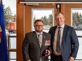 Kyle Scott, left, received his Platinum Jubilee Medal from MLA Martin Long in Edson in January. Scott is a service officer for the Whitecourt Legion and district, and has assisted many veterans in the region with obtaining owed benefits or medals.