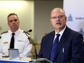 Justice minister Kelvin Goertzen (right) speaks with police chief Danny Smyth looking on during a press conference at RCMP headquarters in Winnipeg on Tues., Feb. 21, 2023. KEVIN KING/Winnipeg Sun