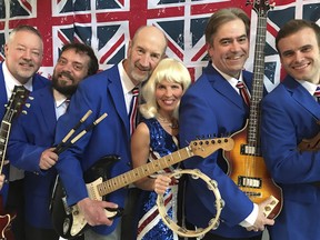 Leisa Way, centre, stands alongside members of the Wayward Wind Band in full costume for their Across the Pond: The British Invasion concert. Submitted