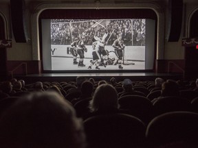 Audience members sit inside the Empire Theatre on Sunday as they watch a screening of Ice-Breaker: The '72 Summit Series during the Belleville Downtown Docfest. ALEX FILIPE