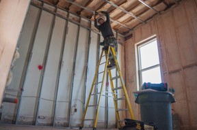 Bill Donaldson, the owner of UrbanRenos, works on the ceiling of an apartment unit inside a heritage building in downtown Stratford.  (Chris Montanini/Stratford Beacon Herald)