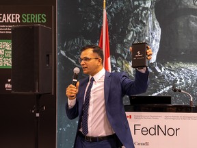 Symboticware CEO Ash Agarwal holds a SymBot while addressing a crowd at the Prospectors and Developers Association of Canada (PDAC) conference in Toronto. The device plugs into a machine and collects data  that is sent to Symboticware’s software platform, called 4-Sight.ai.