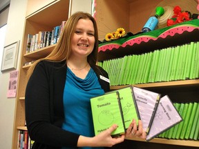 Cassey Beauvais, manager of public services with the Chatham-Kent Public Library, holds up a few of the types of seeds available to take out in this 2019 file photo. (File photo/Postmedia Network)